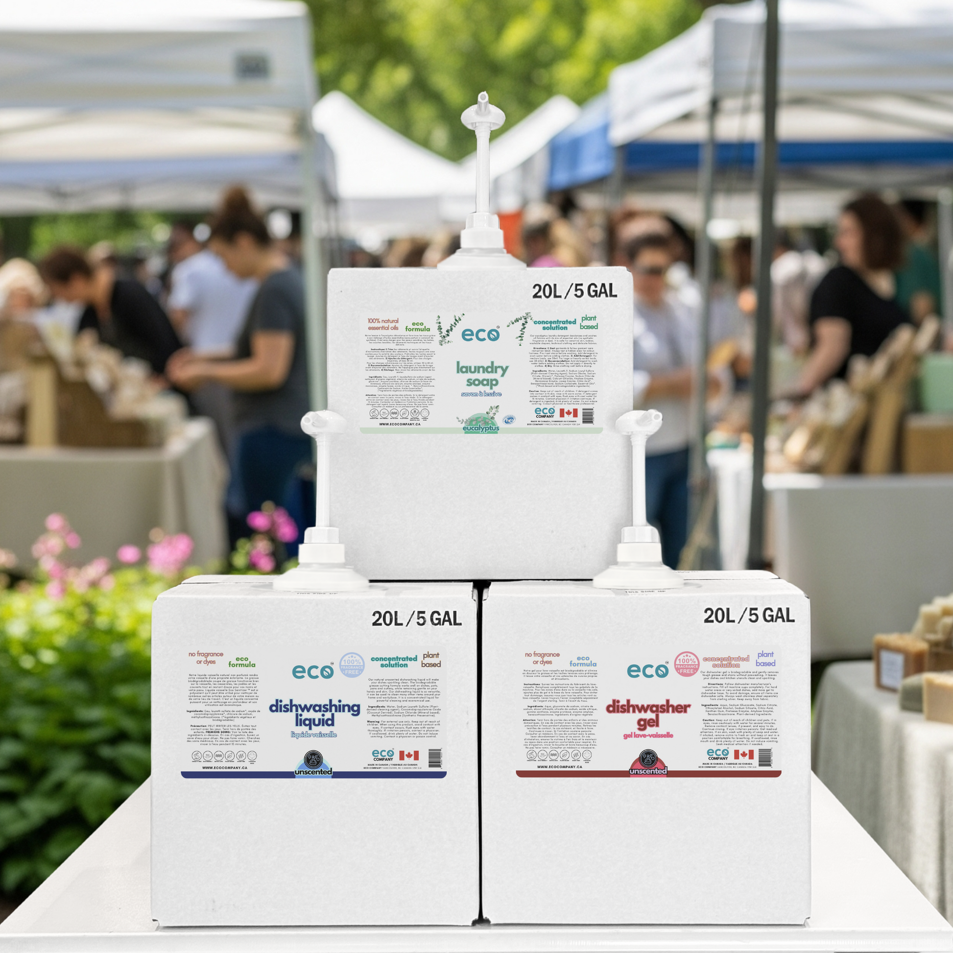 Refill station with refill boxes of bulk dish soap, laundry soap, and dishwasher gel at farmer's market pop-up event.