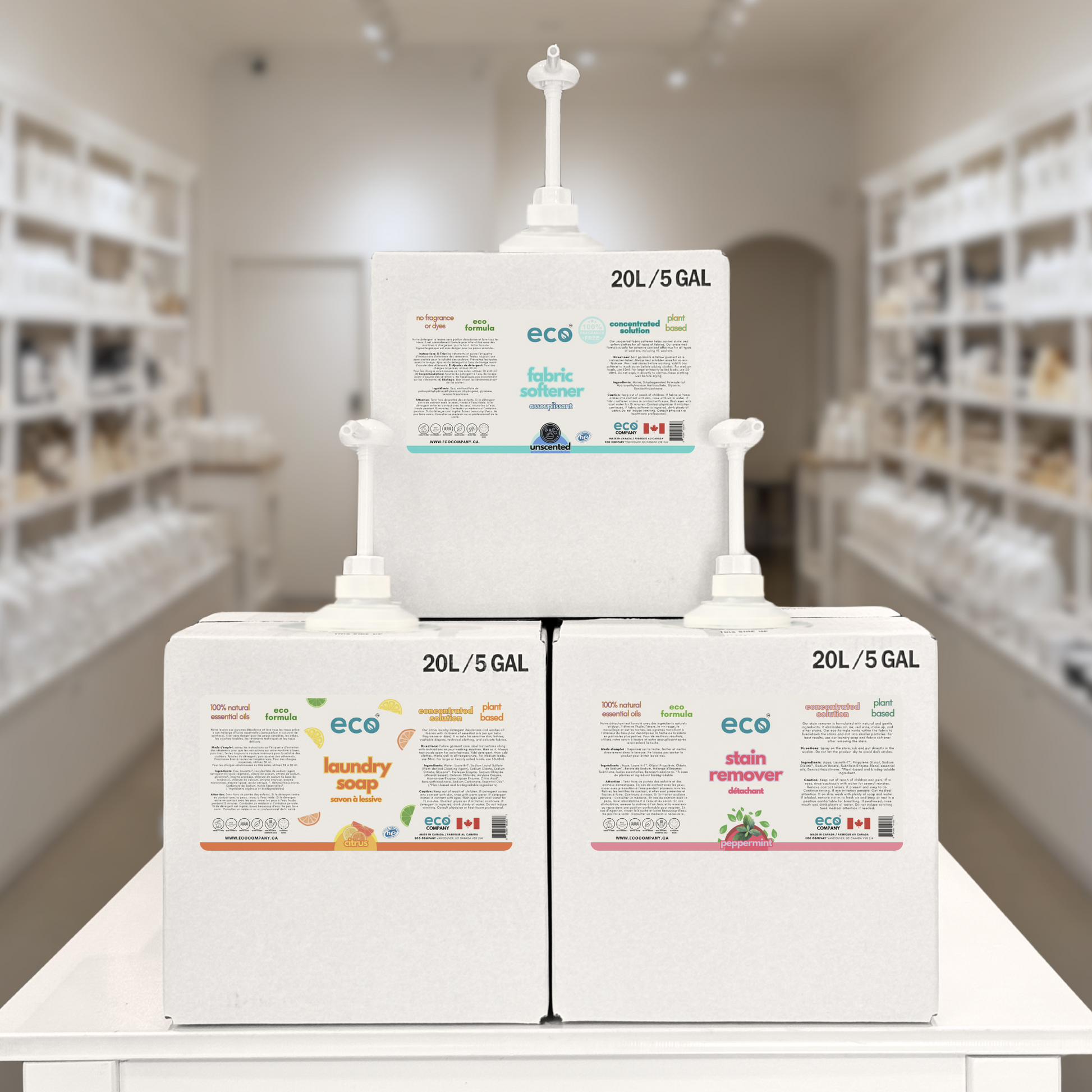 Refill station with refill boxes of bulk fabric softener, laundry detergent, and stain remover at a refill store.