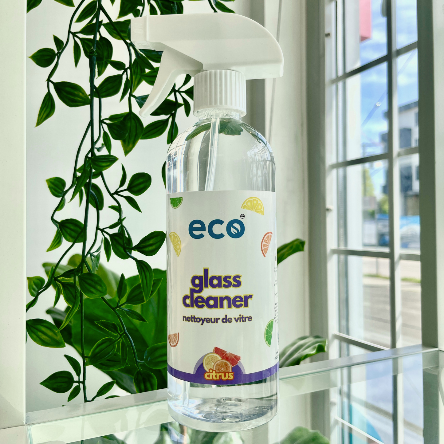 A bottle of eco glass cleaner in citrus, for a plant-based and eco-friendly cleaning routine.