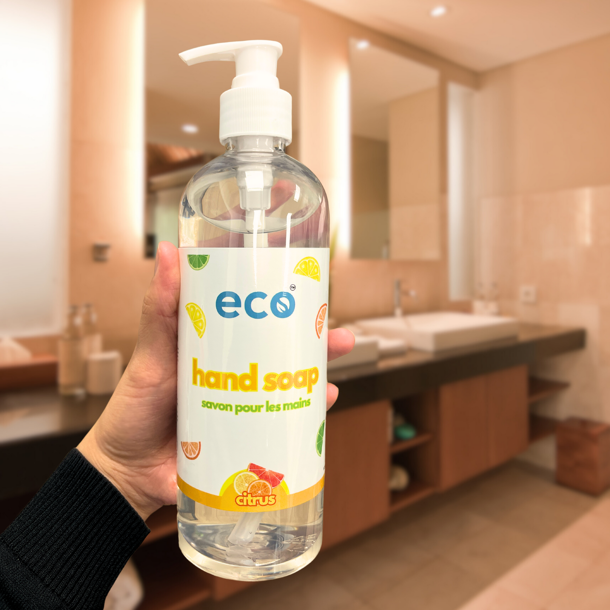 Eco-friendly citrus hand soap bottle in a washroom, promoting a plant-based and sustainable home.