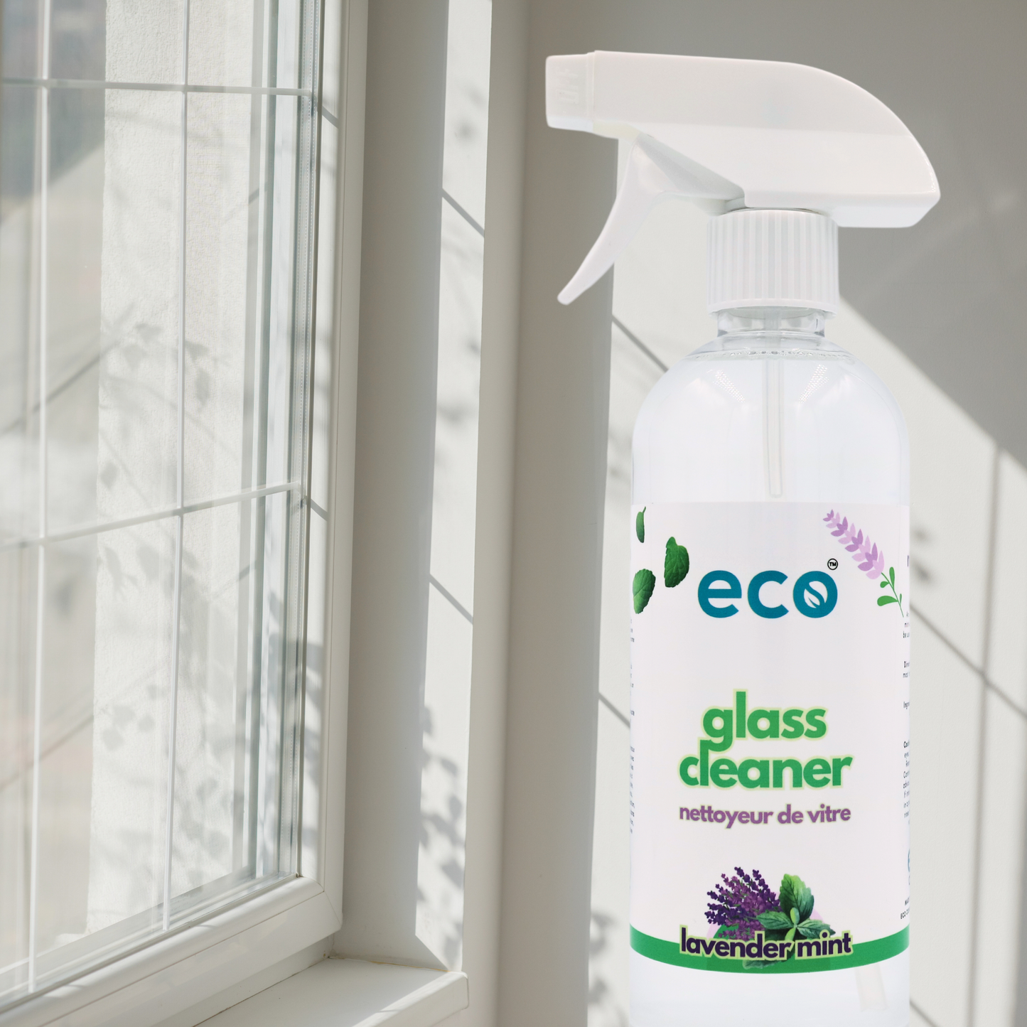 Eco-friendly glass cleaner with streak-free shine, shown by clear windows.